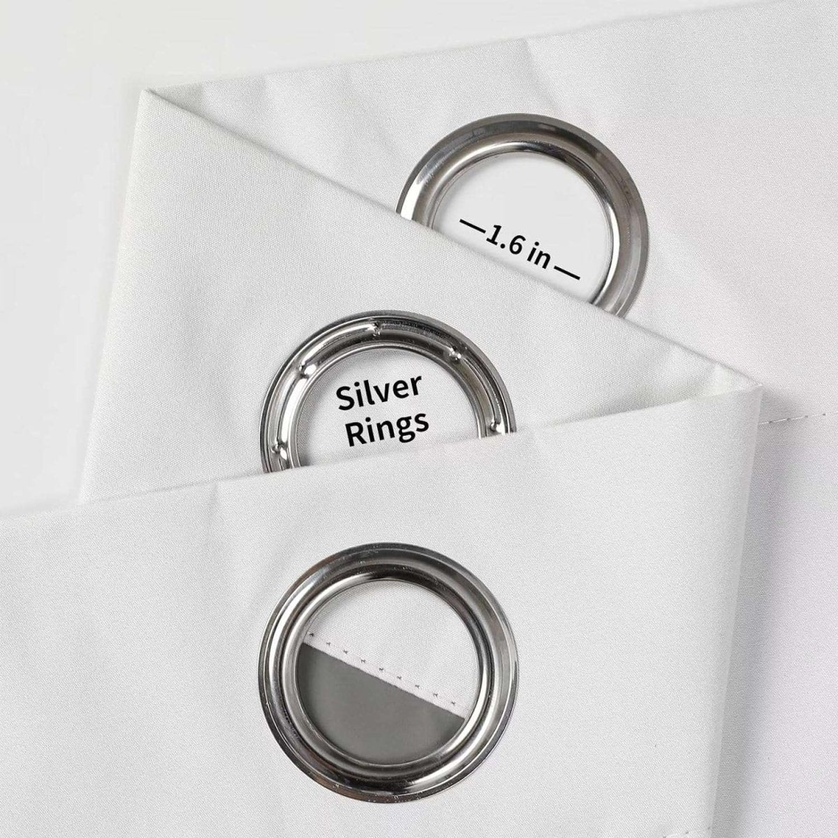Close-up of white Joydeco blackout curtain fabric showing silver grommets with "Silver Rings" and "-1.6 in-" labels.