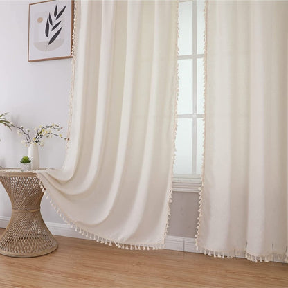 Creamy beige boho linen curtains with tassel trim, semi-sheer fabric creating soft ambiance for living room.