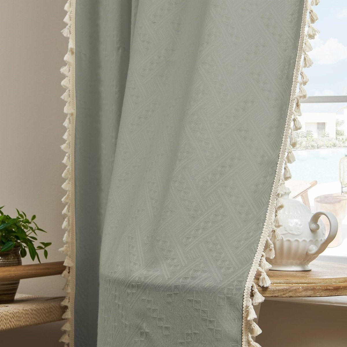 Sage green boho linen sheer curtains with subtle geometric pattern and cream tassel trim for farmhouse style living room.