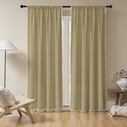 Khaki linen boho curtains with white tassels, light filtering farmhouse style, in a room with chair and lamp.