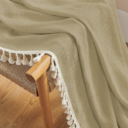 Close up of khaki linen sheer curtain with white tassels, showcasing boho farmhouse texture and country rustic charm.