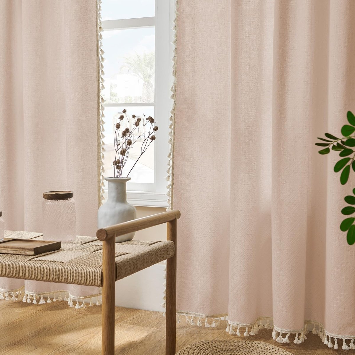 Pink linen sheer curtains with geometric pattern and cream tassel fringe on living room window.