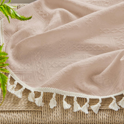 Close up of Joydeco boho pink linen sheer curtain with diamond pattern and cream tassel trim.