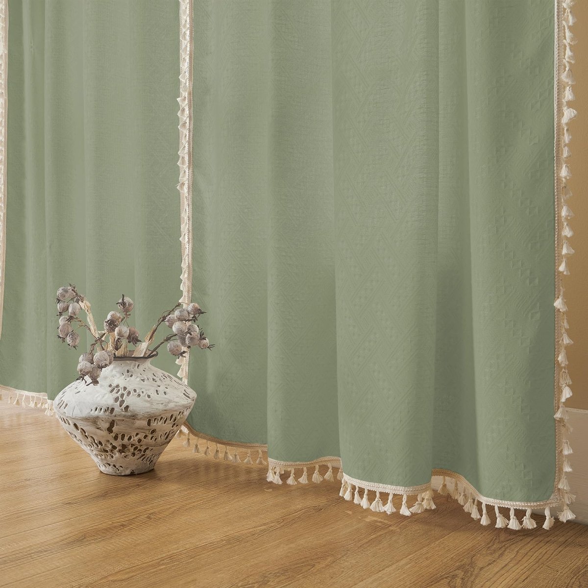 Sage green linen boho curtains with cream braided trim and tassels, farmhouse style decor.
