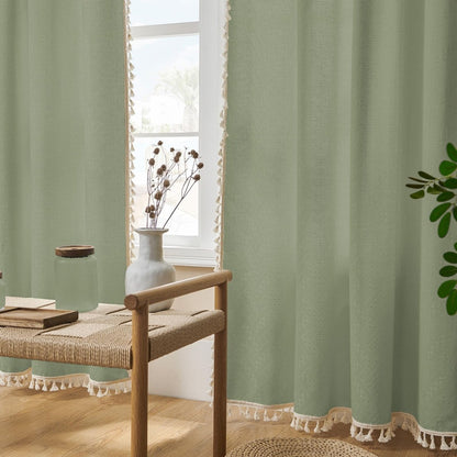 Sage green linen curtains with cream tassels, light filtering, boho farmhouse style decor.