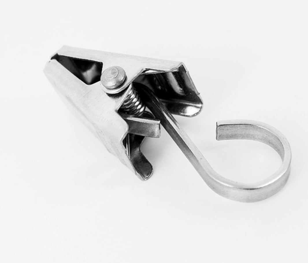 Single small Joydeco stainless steel curtain clip with integrated hook and spring mechanism, showcasing brushed metal finish.