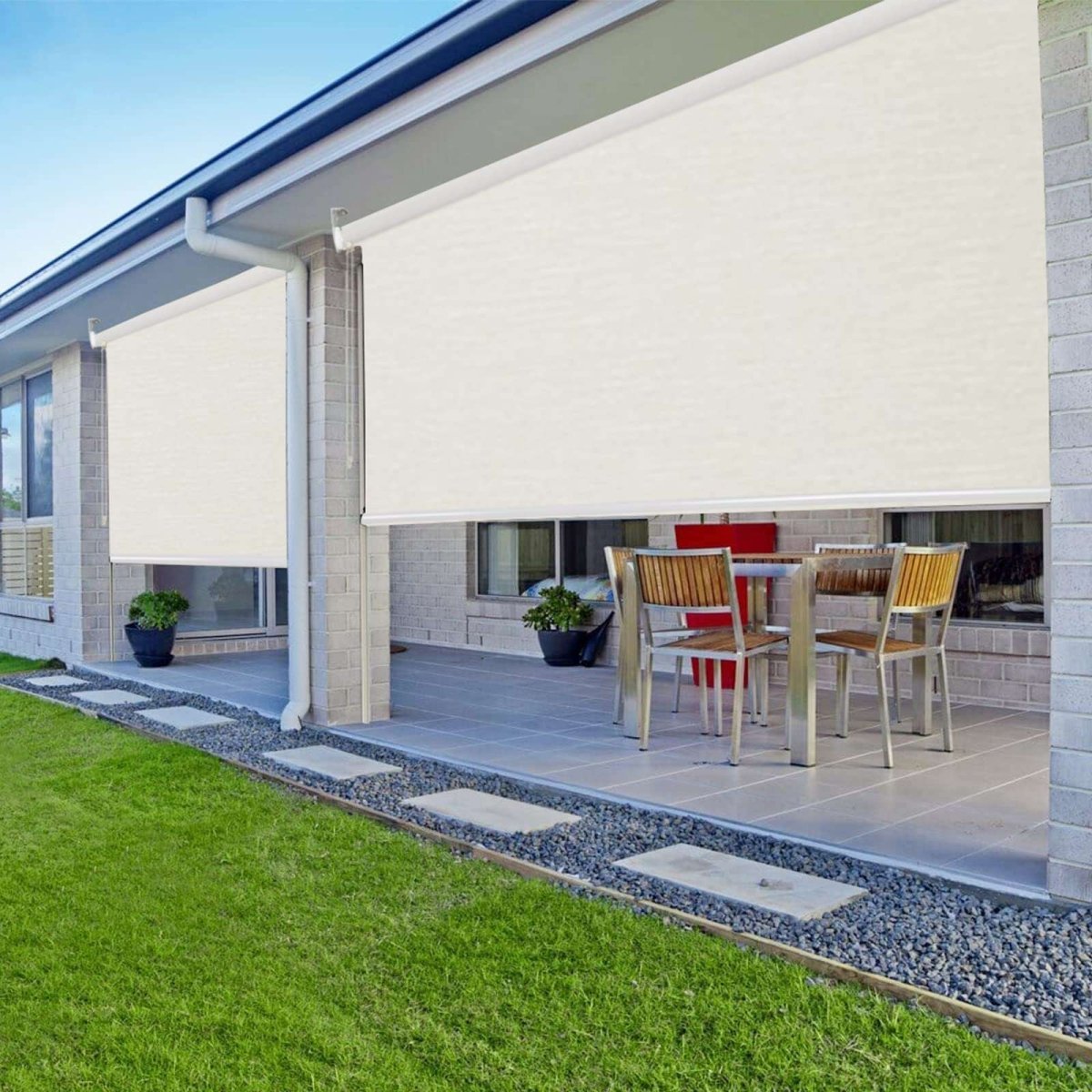 Joydeco beige blackout roller shades on a modern patio, providing privacy for outdoor dining area.