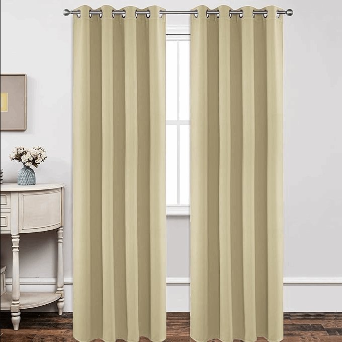 Joydeco light beige grommet blackout curtains hanging in a room, showcasing their blackout and light-blocking features.