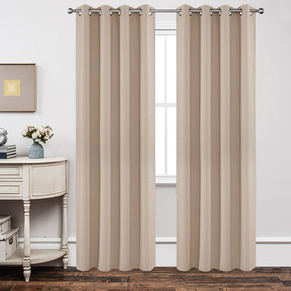 Joydeco Classic Beige Grommet Blackout Curtains hanging on silver rod, covering window, light-blocking design.