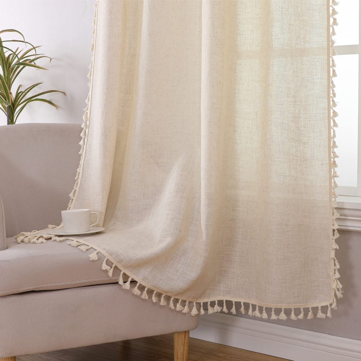 Cream boho linen curtain with tassel trim, showing texture and light-filtering quality. Ideal for living rooms.