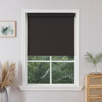 Dark gray cordless blackout roller shade from Joydeco, installed in a white window. Offers 100% light blockage.