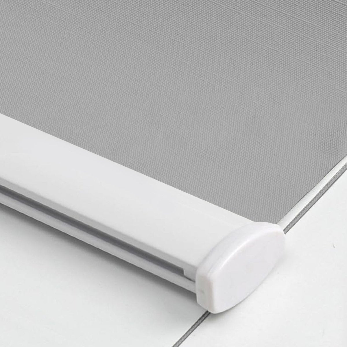 Light gray striped jacquard blackout roller shade fabric, white aluminum bottom rod. Product detail view.
