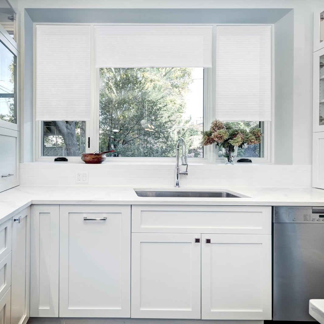 Joydeco white cordless cellular shades on kitchen window, light filtering honeycomb texture.