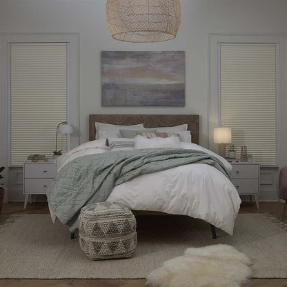 Cream cordless blackout cellular shades in a bedroom, showing product integration and light blocking feature.
