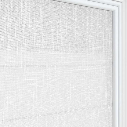 Close up of Joydeco white linen blend Roman shade texture with horizontal folds filtering light.
