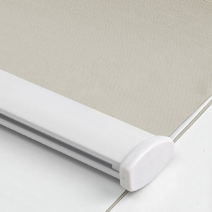 Close-up of light beige woven blackout roller shade fabric texture with white aluminum bottom bar and end cap.
