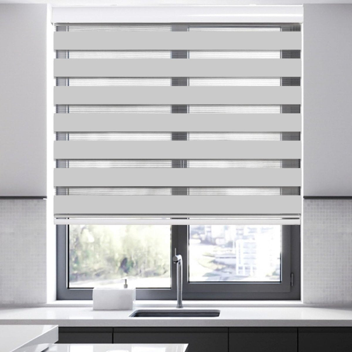 Joydeco modern white cordless light filtering zebra shade installed on kitchen window over sink.