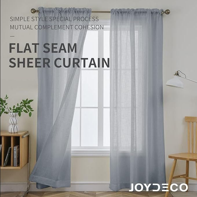 Joydeco light blue-gray sheer linen-like curtains with flat seams hanging from a rod, filtering light in a room setting.