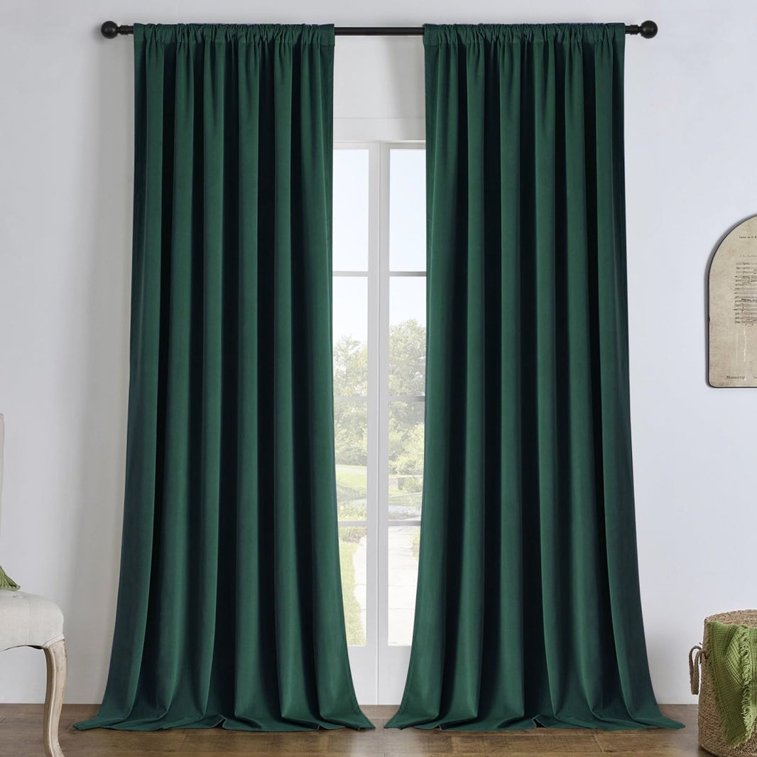 Hunter green linen blackout curtains hanging on a black rod, offering energy efficiency and privacy for any room.