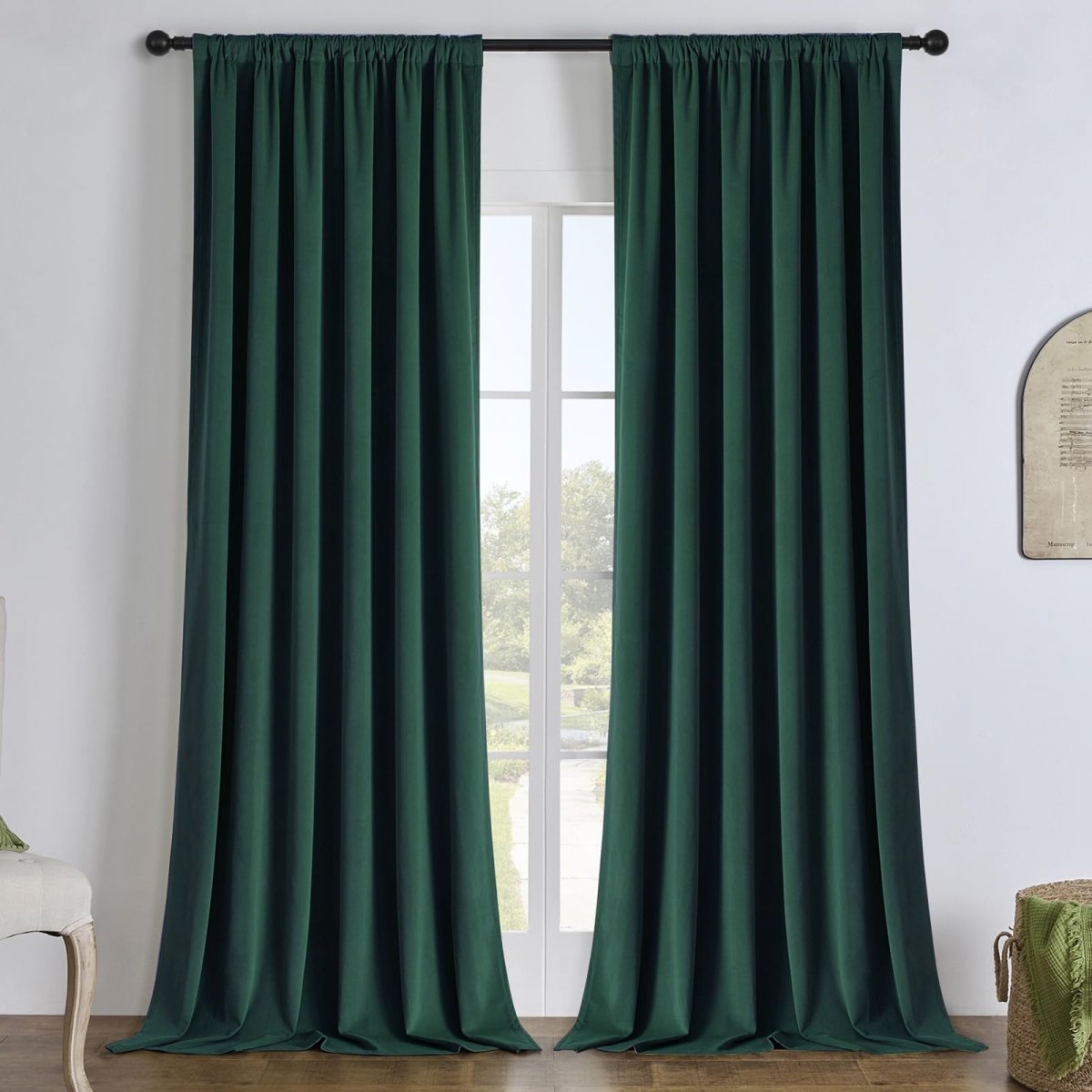 Hunter green linen blackout curtains hanging on a black rod, offering energy efficiency and privacy for any room.