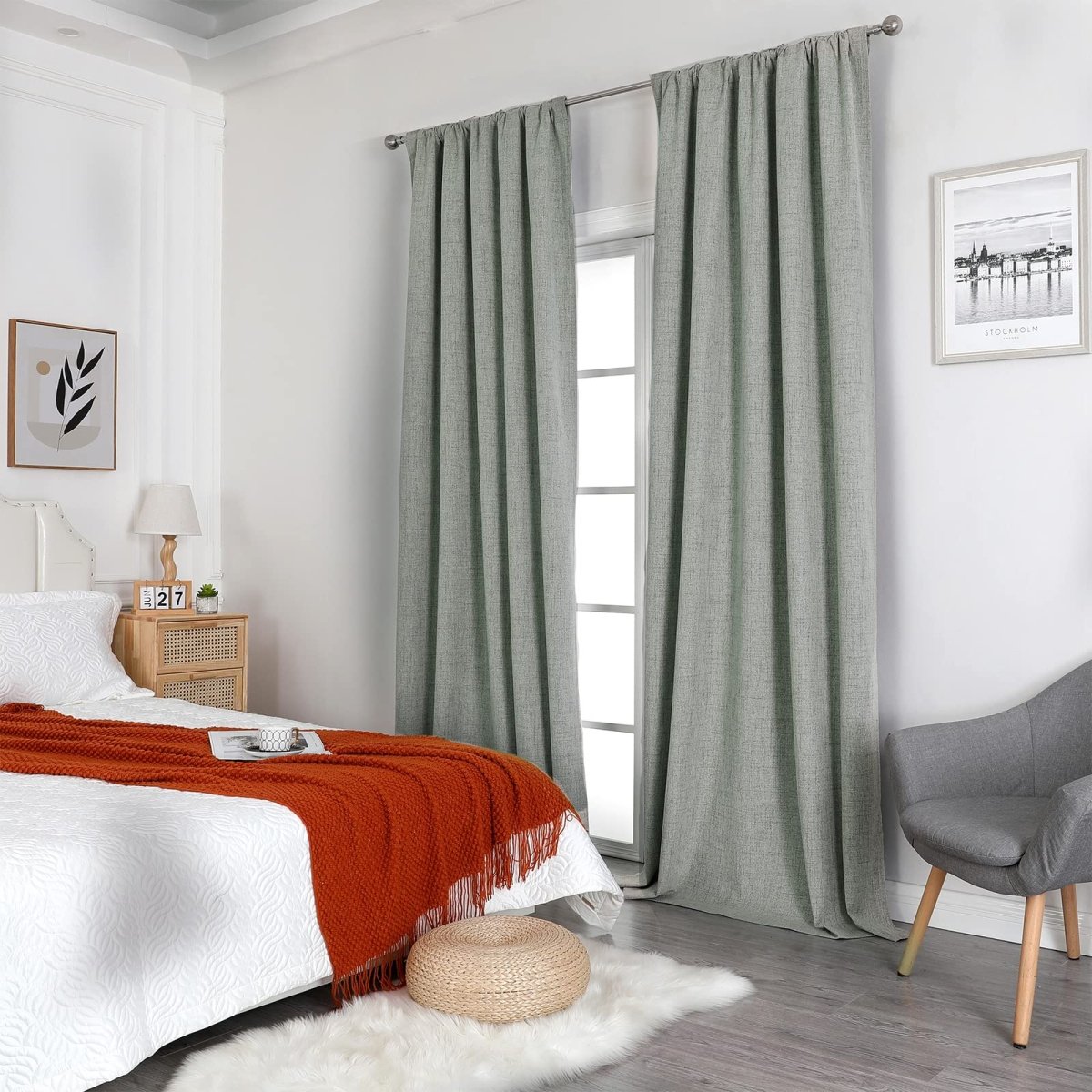 Sage green linen blend blackout curtains in bedroom, thermal insulation, light blocking. Showcased on silver rod.