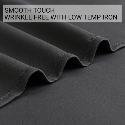 Dark grey blackout curtain fabric close-up: smooth, wrinkle-free polyester. Shows stitching, highlighting material quality and care.