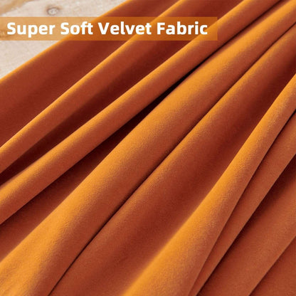 Close-up of burnt orange velvet fabric showcasing soft folds and plush texture of Joydeco blackout curtains.