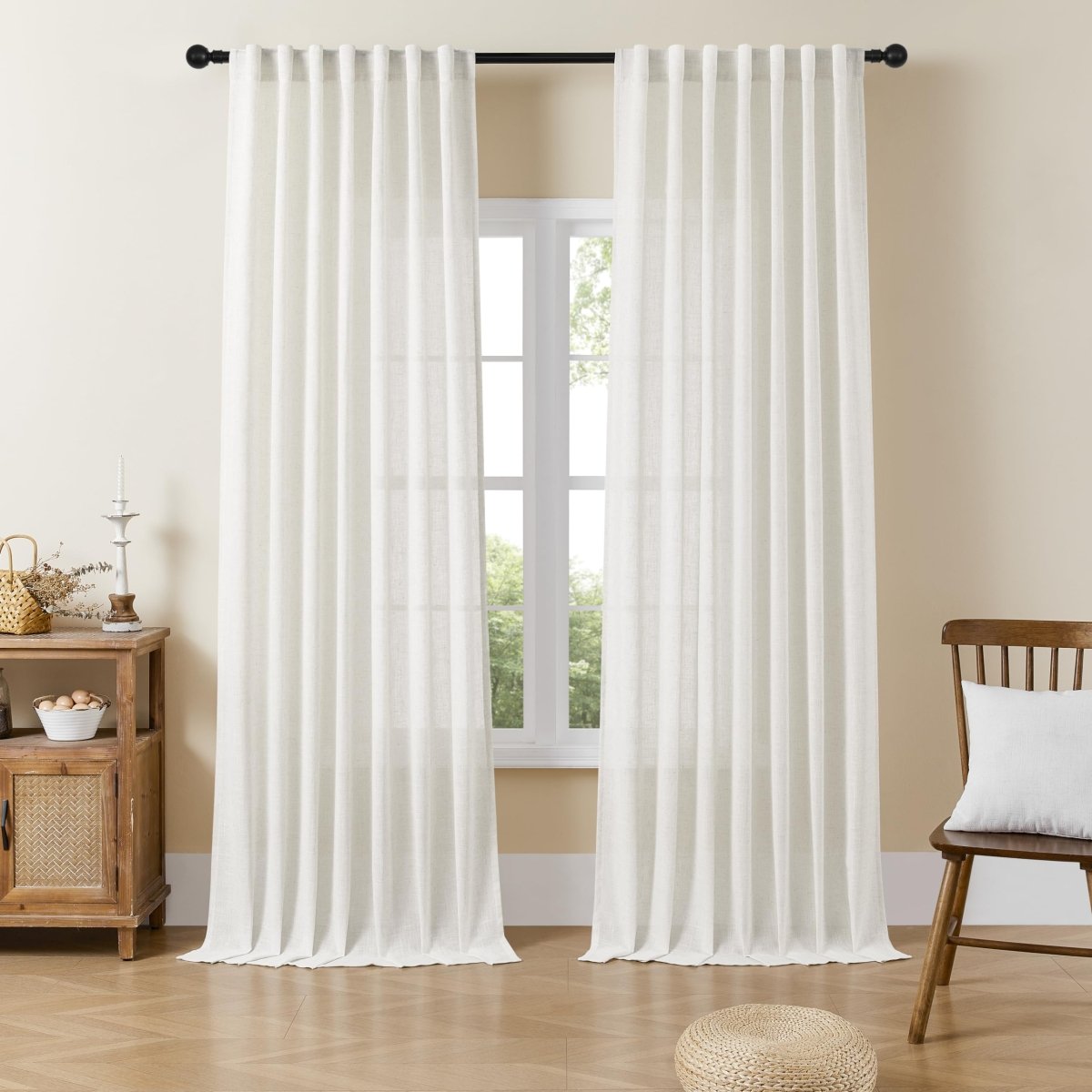 Off-white linen sheer curtains filtering light in a bright living room.