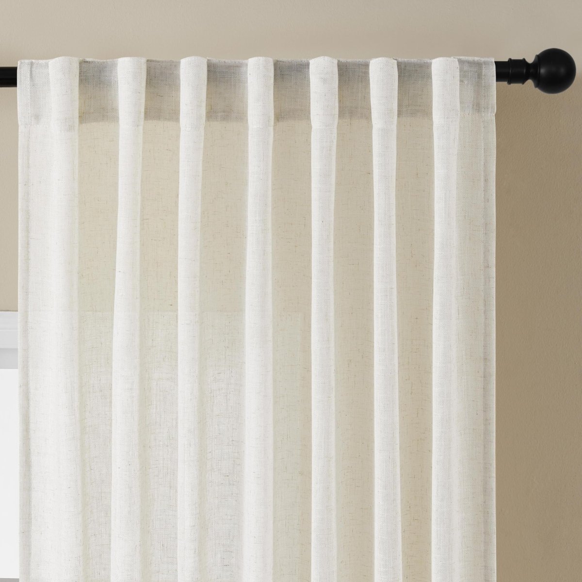 Close-up of off-white Joydeco linen sheer curtains with back tabs, showing texture and light filtering.