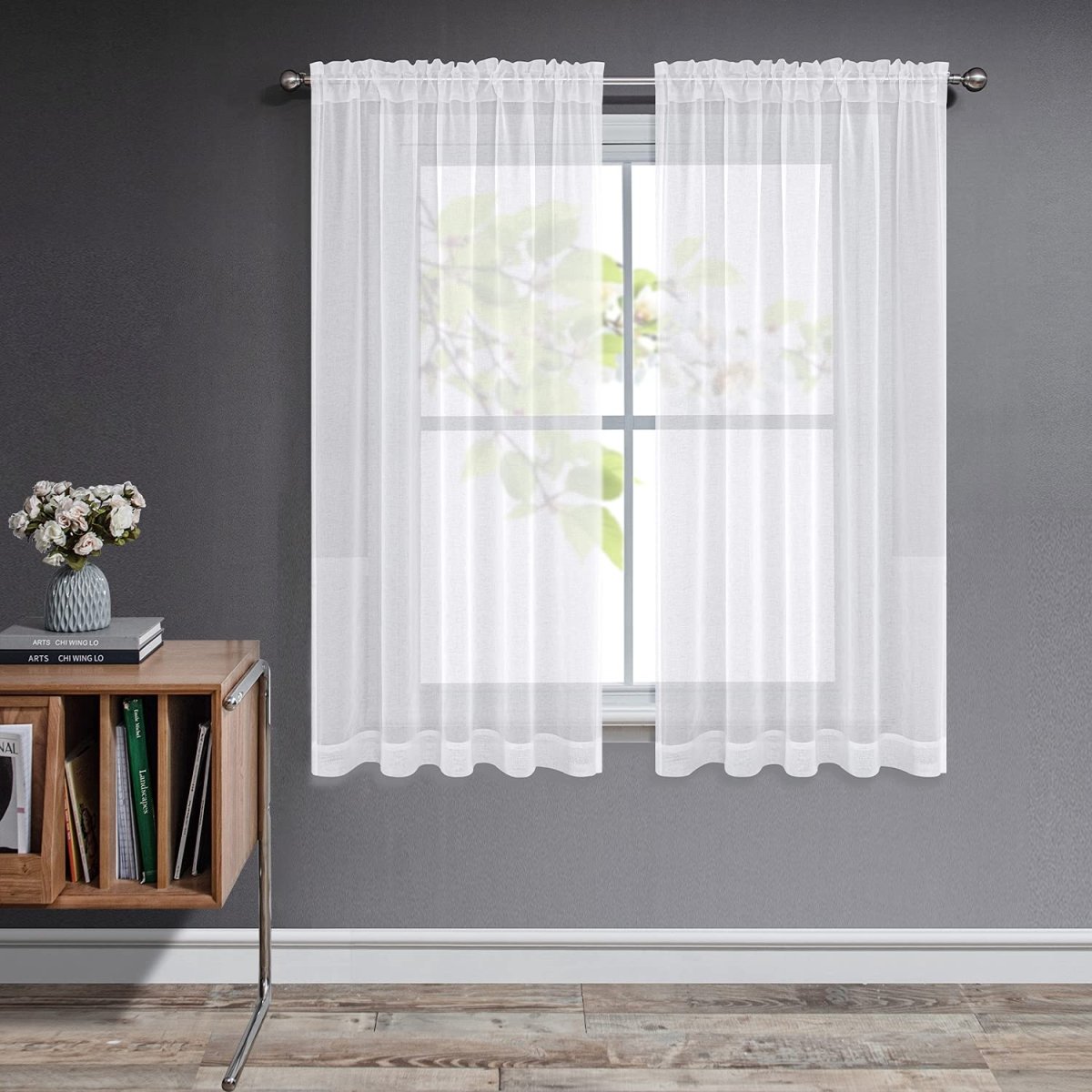 Off-white sheer curtains with rod pocket, Joydeco brand, on window with natural light.