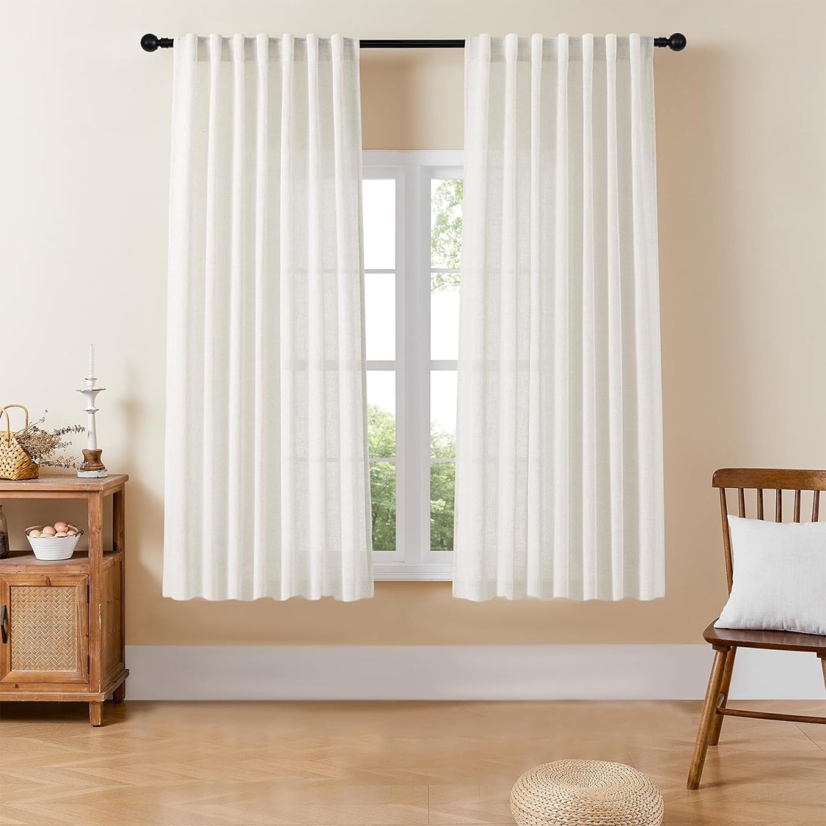 Joydeco off-white semi-sheer linen blend curtains with pinch pleats, filtering light in a bright room.