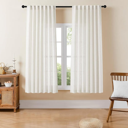 Joydeco off-white semi-sheer linen blend curtains with pinch pleats, filtering light in a bright room.