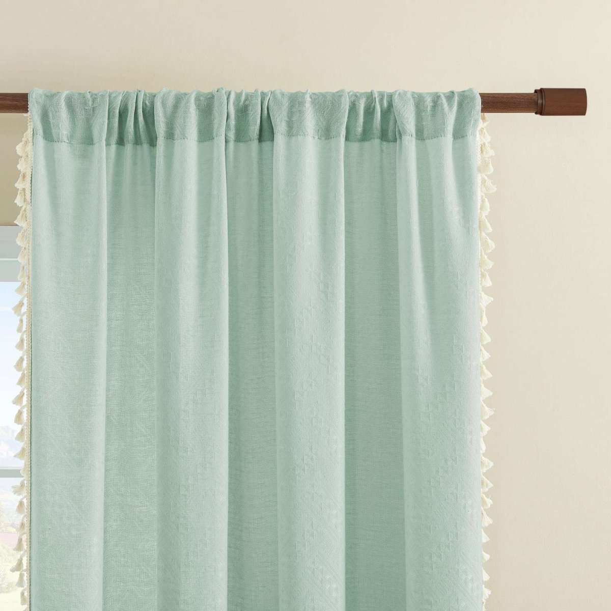 Joydeco mint green linen sheer curtains with cream tassel trim and embroidery on wooden rod.