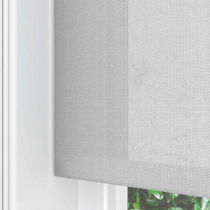 Light gray Joydeco traditional cordless solar shade, woven texture, partially covers window with greenery.