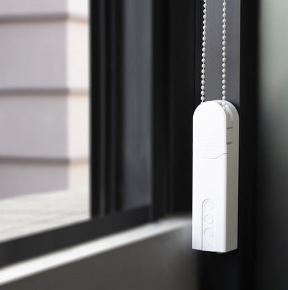 White Joydeco smart chain roller blind motor attached to window frame, with three control buttons.