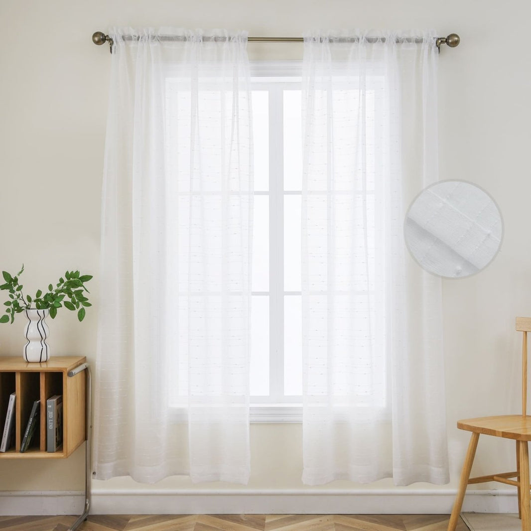 Joydeco white sheer curtains with textured weave, allowing natural light to filter through a window.