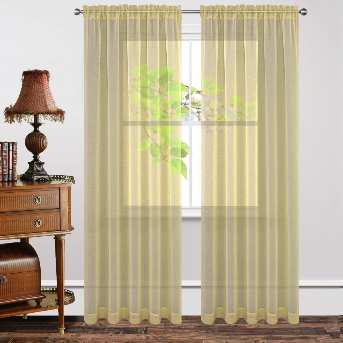 Yellow sheer rod pocket curtains with diamond embroidery, allowing light while maintaining privacy.